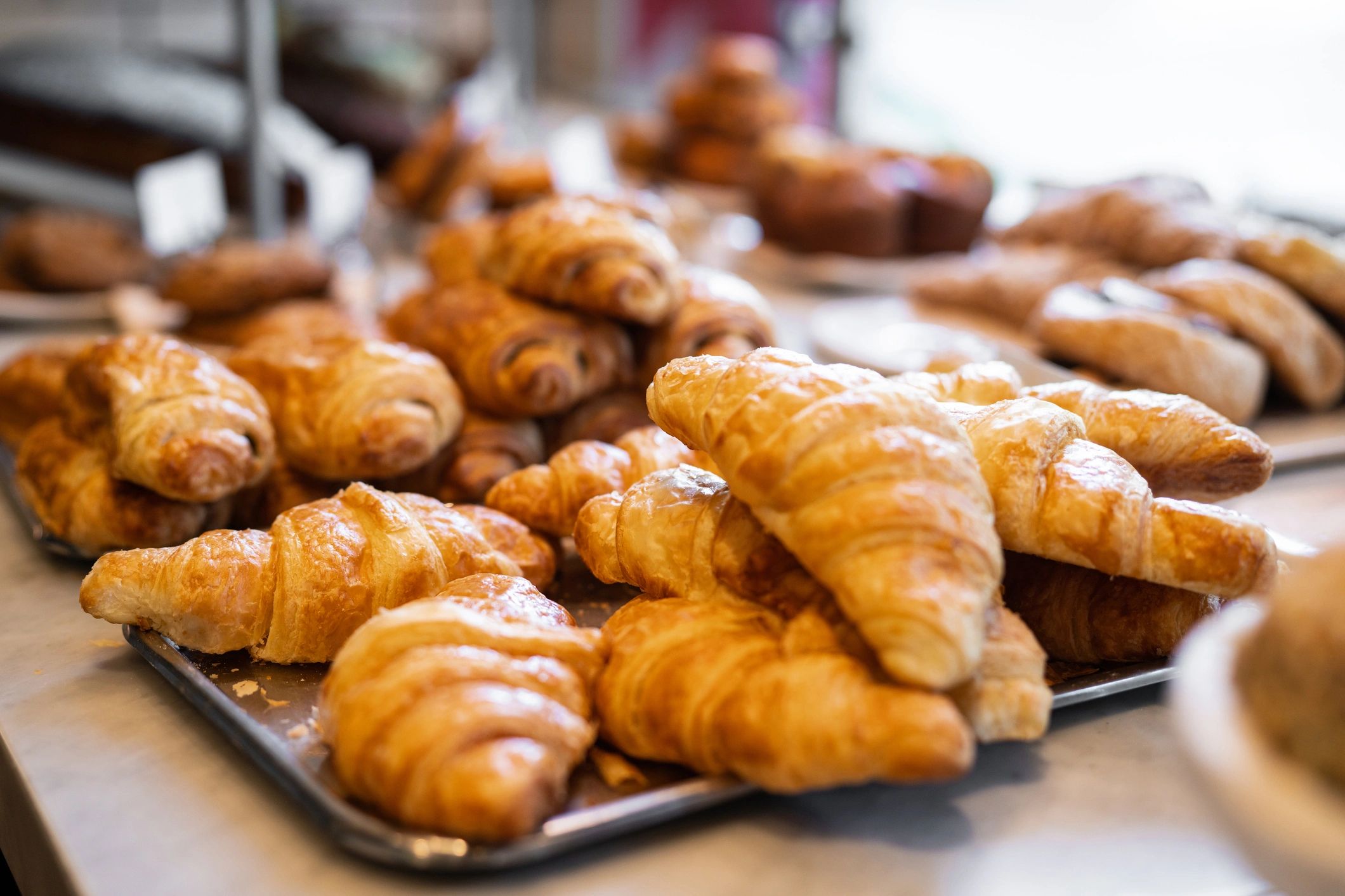 Close-up of fresh croissants in a bakery display