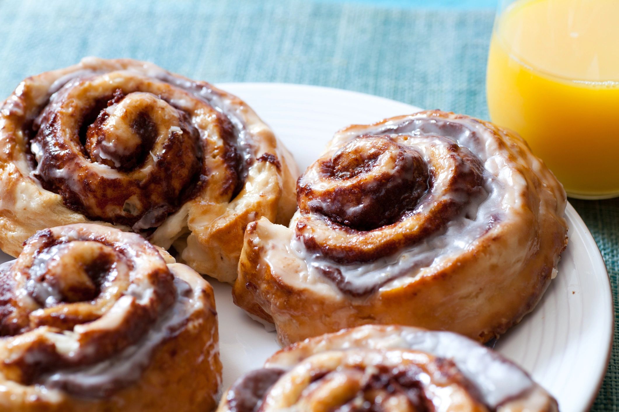 Cinnamon rolls with orange juice on a table