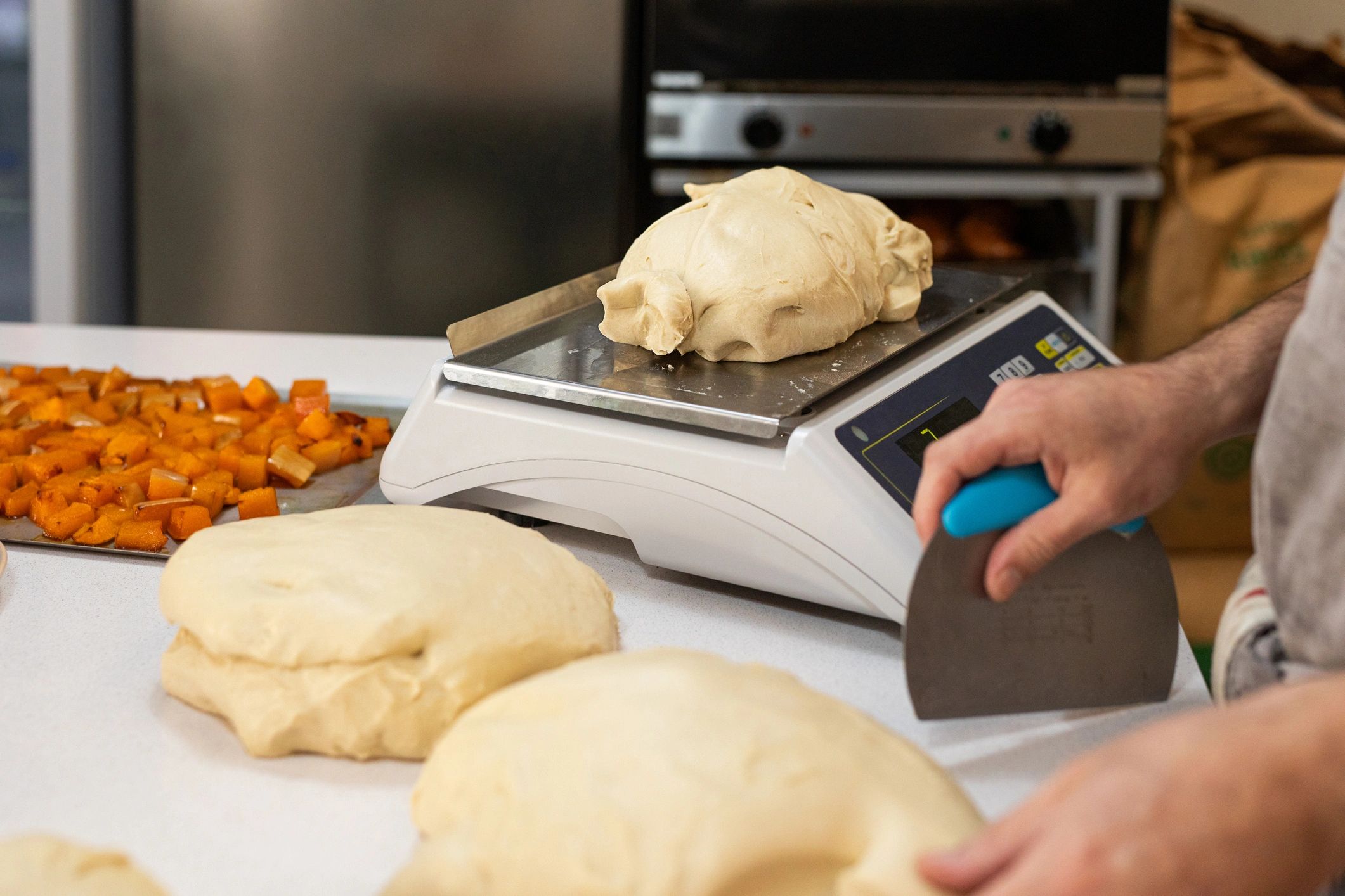 Cutting and weighing fresh dough for bread